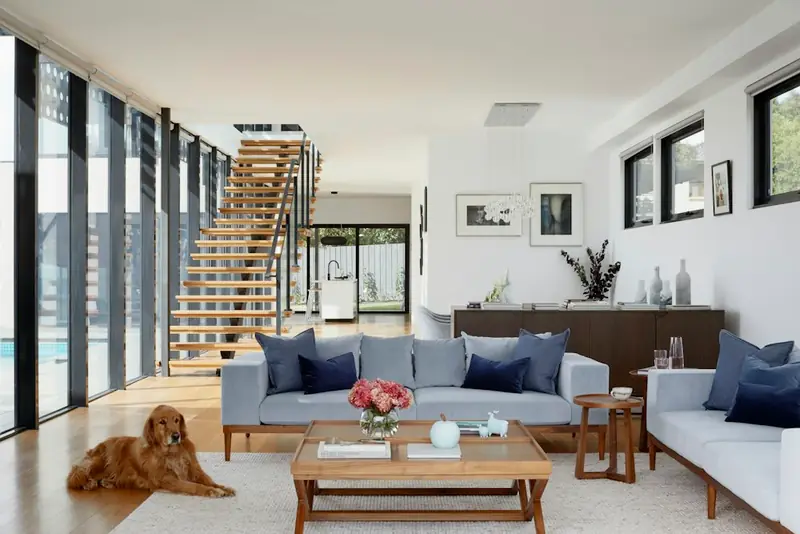 Illustrative open-plan living room with sofas and a staircase