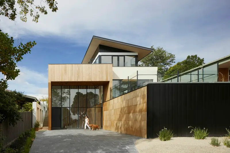 Illustrative timber-clad house exterior with a sheltered terrace